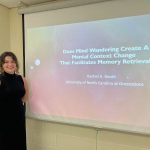 Picture of Rachel Booth next to her thesis title slide.