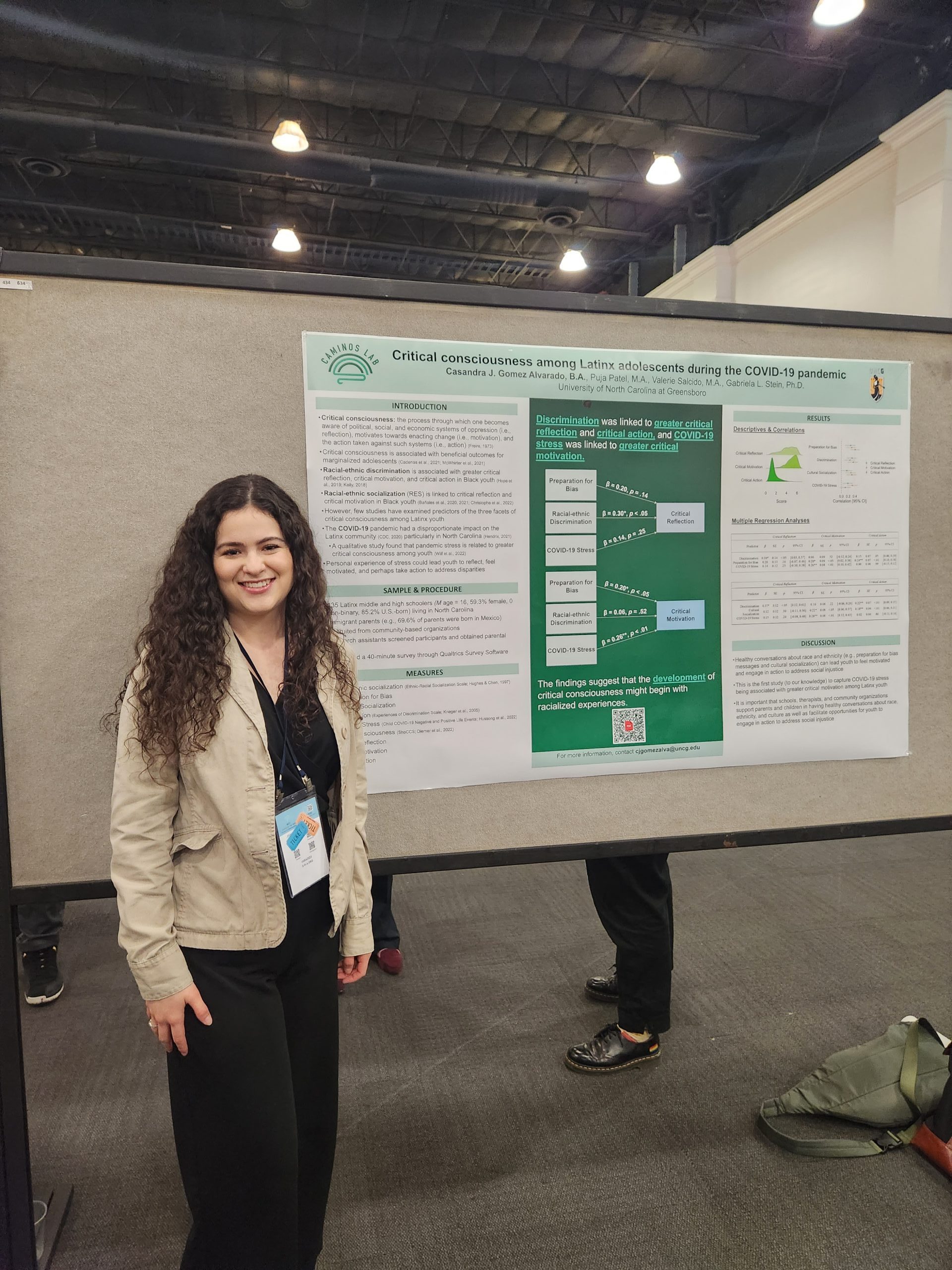 Gomez Alvarado standing by her conference poster