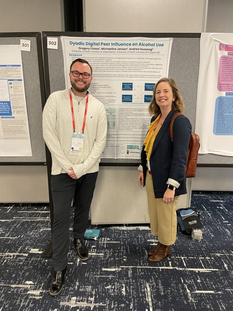 Greg and Mikey by a poster