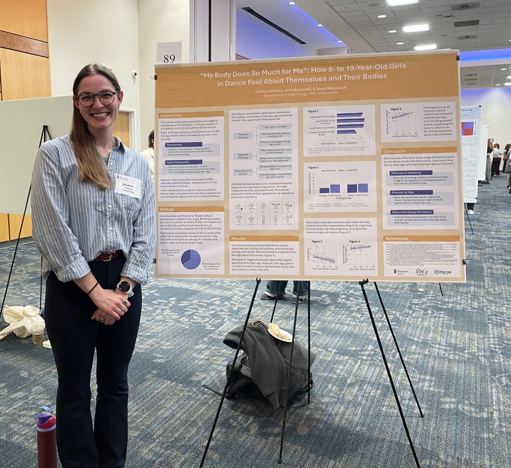 Peebles standing by poster.